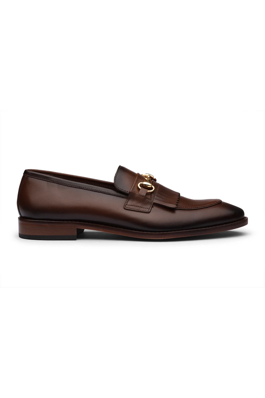Brown leather loafer with gold buckle on a white background