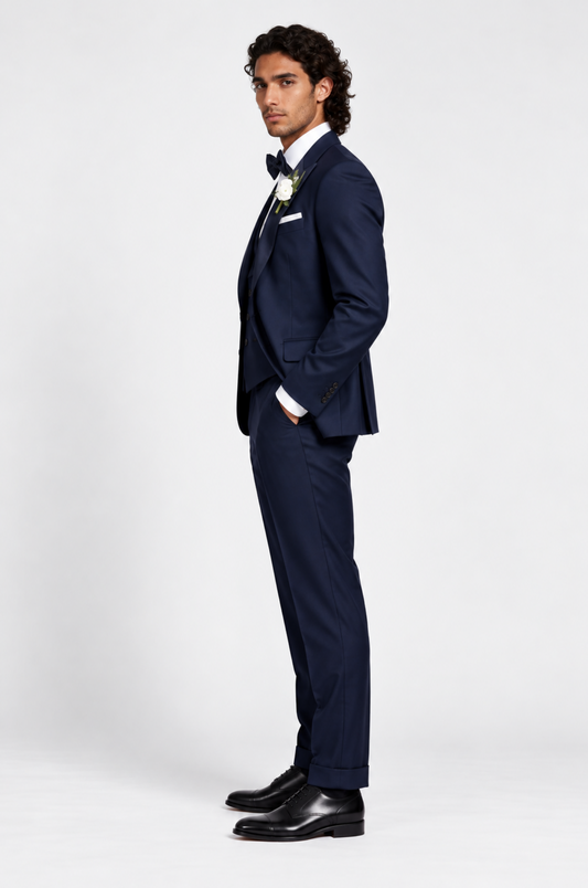 A stylish foreign man confidently wearing a tailored navy suit by Blutailor, showcasing a modern and sophisticated look. The suit features sharp lines and a sleek silhouette, perfectly complementing his unique style.