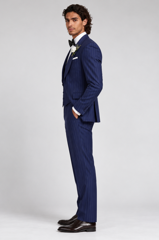 A stylish foreign man confidently wearing a tailored pinstripe suit by Blutailor, showcasing a modern and sophisticated look. The suit features sharp lines and a sleek silhouette, perfectly complementing his unique style.