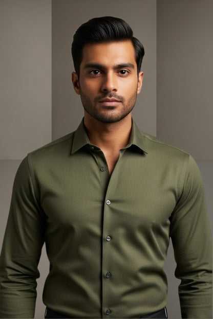 Man wearing a green shirt against a plain background