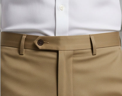 White shirt with a brown belt and beige pants against a gray background
