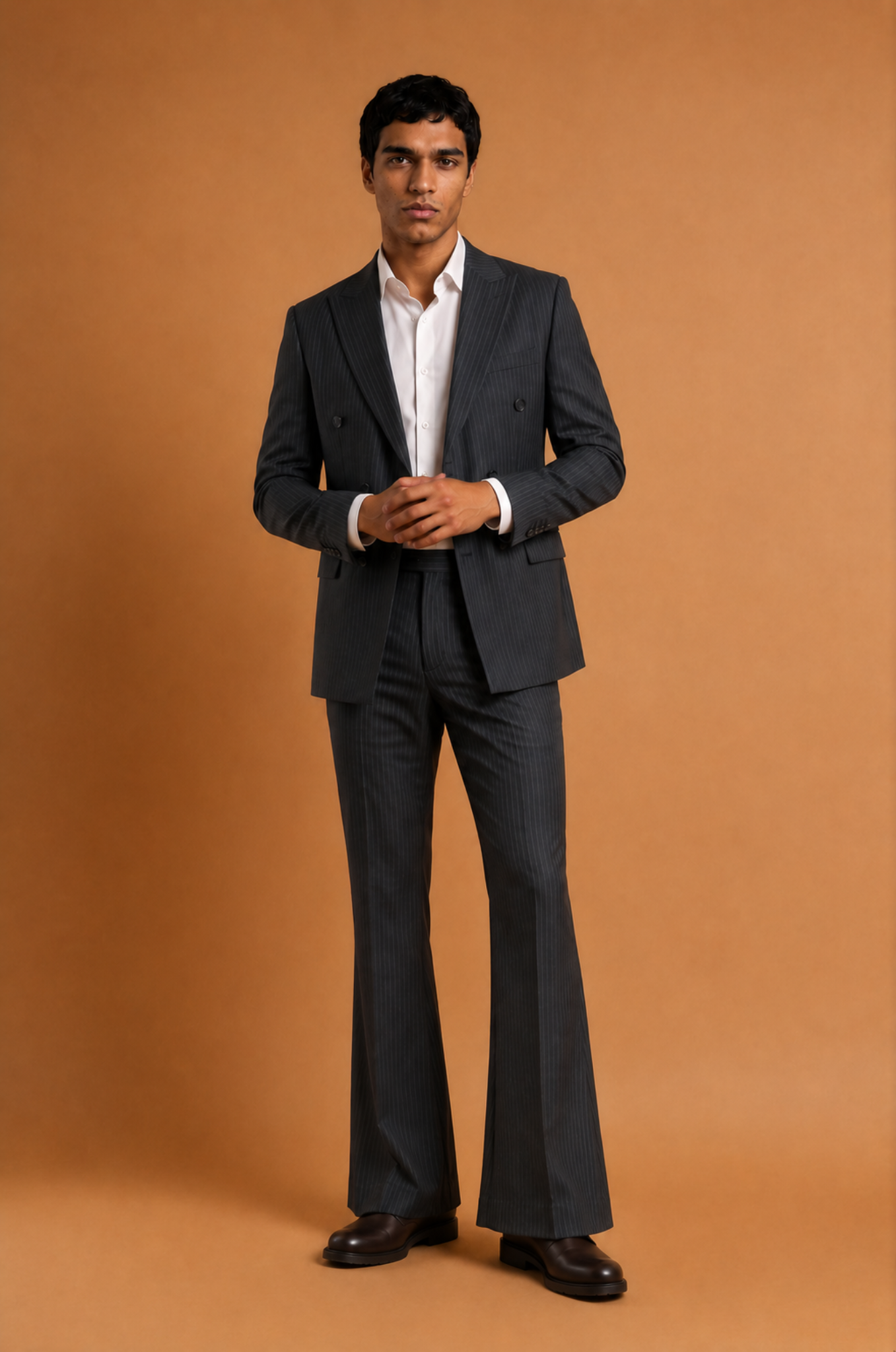 Blutailor charcoal grey pinstripe bell bottoms double-breasted suit in premium fabric with a bespoke tailored fit, featuring a structured blazer and subtle flared trousers for a sharp, sophisticated look.