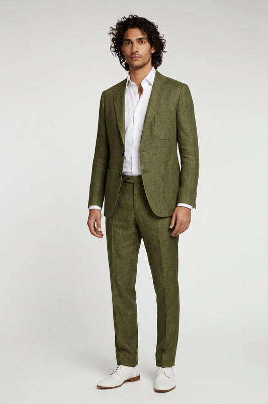 Man wearing a green suit with a white shirt and white shoes on a light gray background