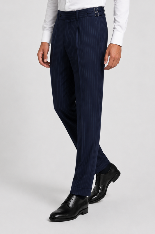 Men's Blutailor Sovereign Navy Pinstripe Gurkha Pant crafted from premium terry rayon fabric, featuring a sophisticated navy blue base with classic pinstripe detailing, a high-waisted Gurkha-style waistband with adjustable side fasteners, double-pleated front, tailored tapered silhouette, and a refined aesthetic ideal for formal wear, business attire, weddings, and elevated occasion dressing.