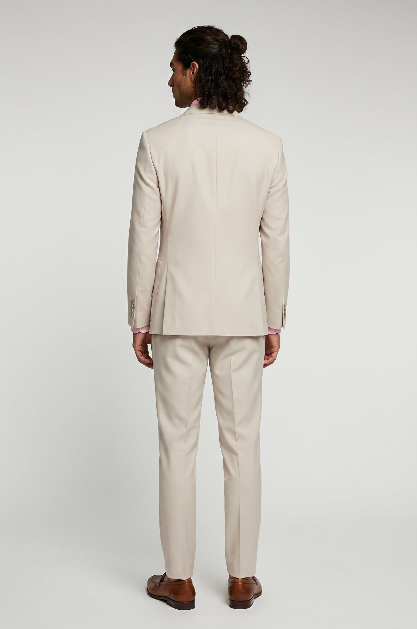 Man wearing a beige suit on a white background