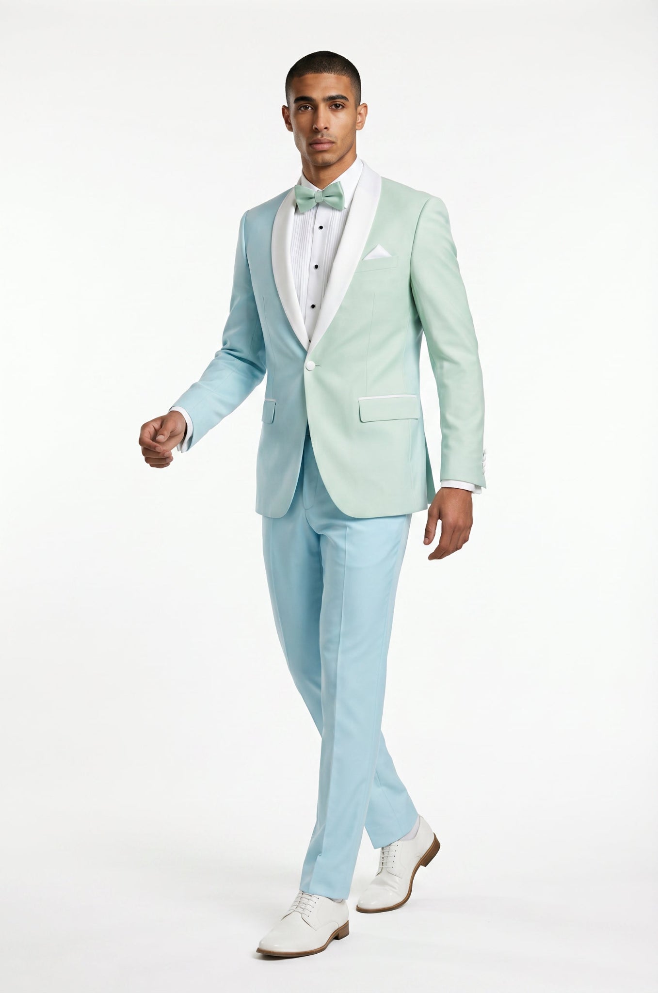 Man wearing a light blue suit with a white shirt and bow tie on a white background