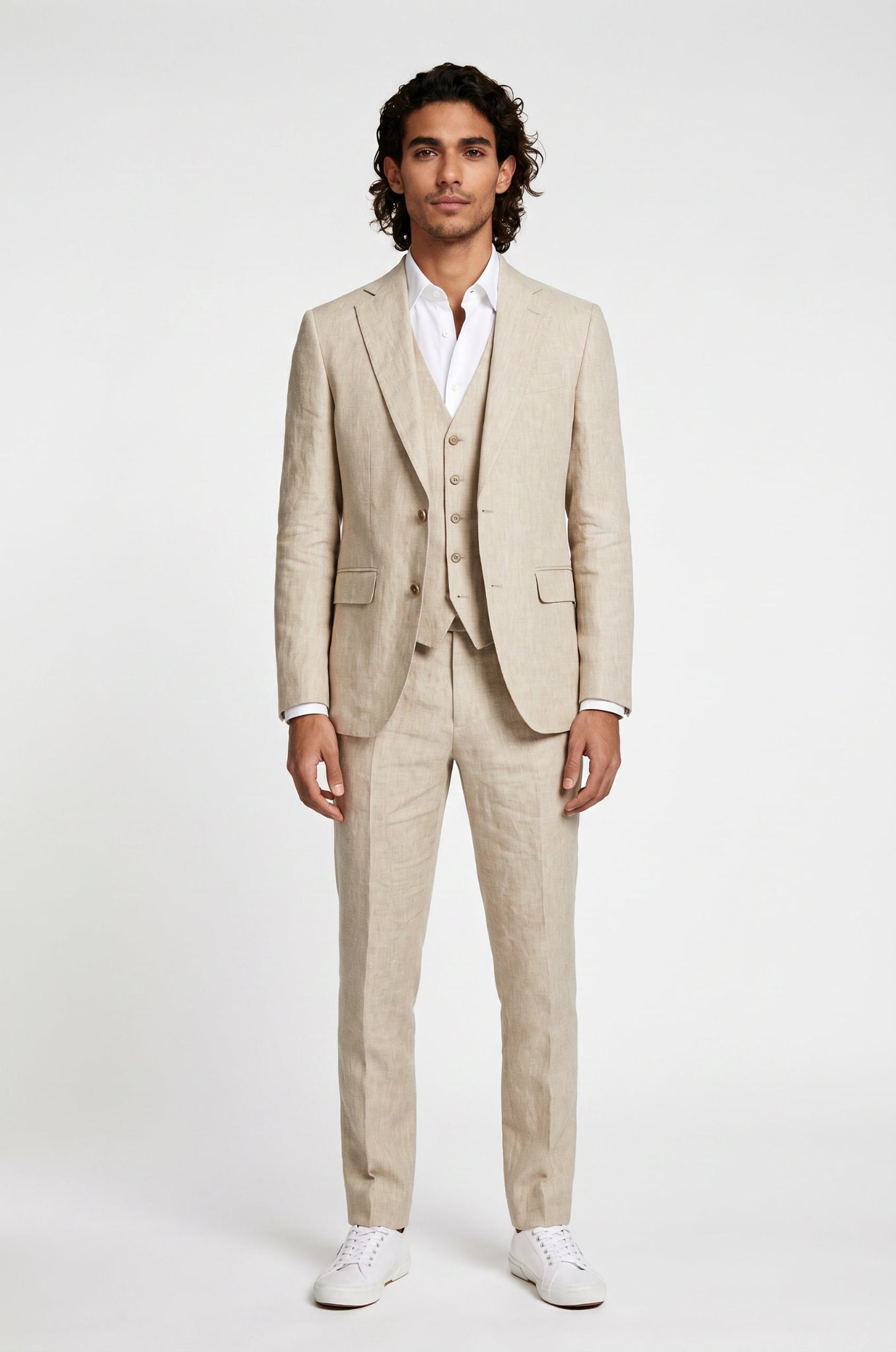 Man wearing a beige suit with a white shirt on a white background