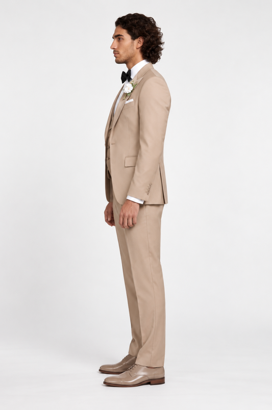 A stylish foreign man confidently wearing a tailored beige suit by Blutailor, showcasing a modern and sophisticated look. The suit features sharp lines and a sleek silhouette, perfectly complementing his unique style.