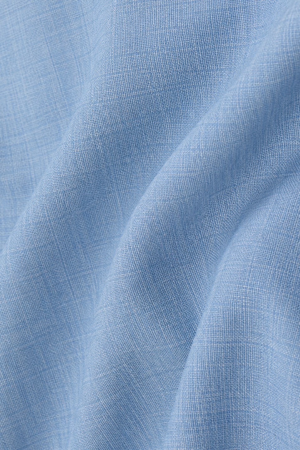 A close-up of light blue woven fabric with a subtle linen-like texture and soft folds.